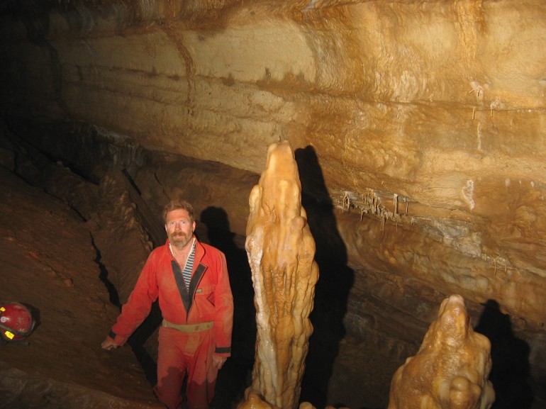 Steve standing near a couple of large stalagmites.